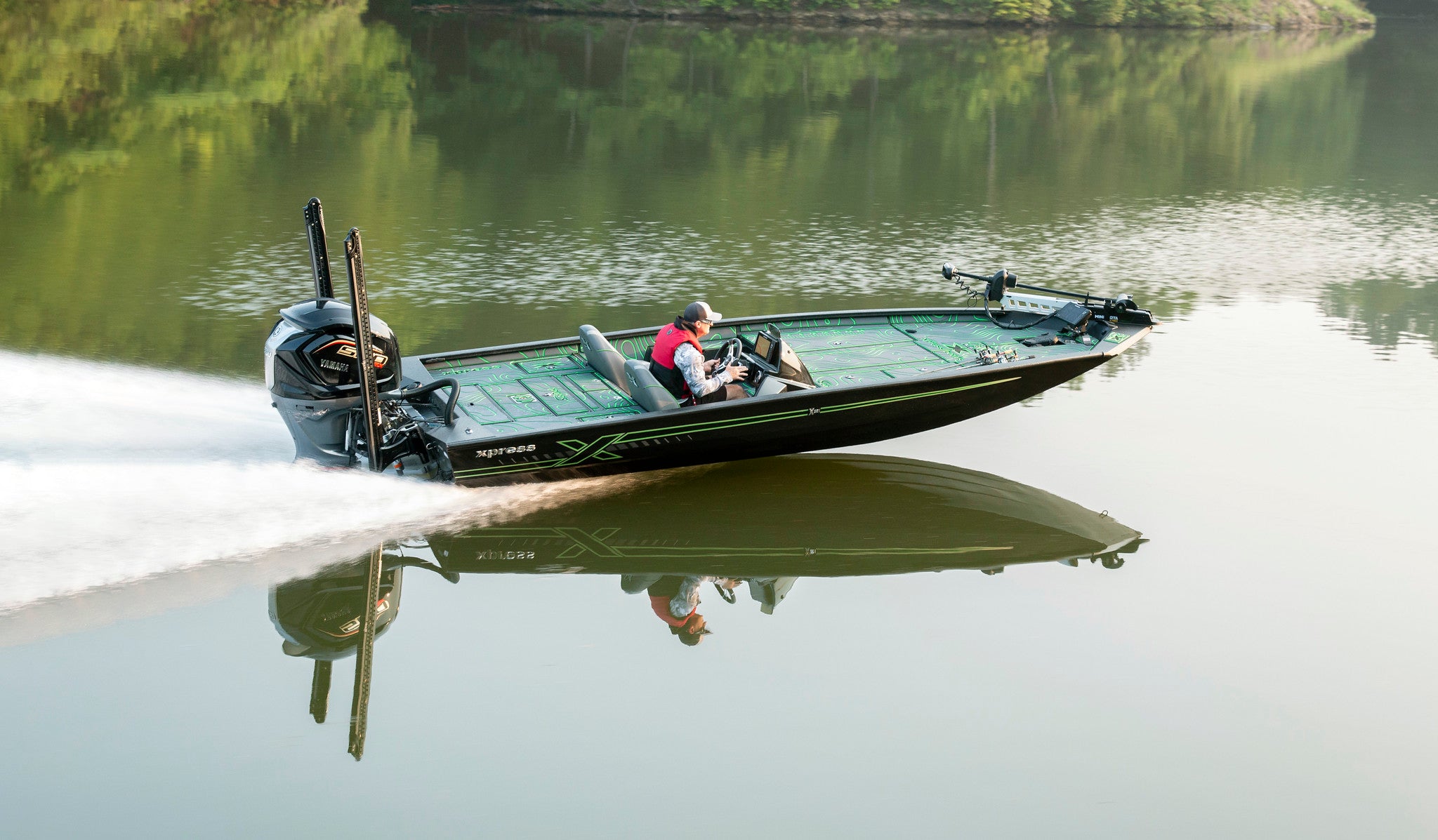 Xpress fishing boat with custom SeaDek running across a Minnesota lake