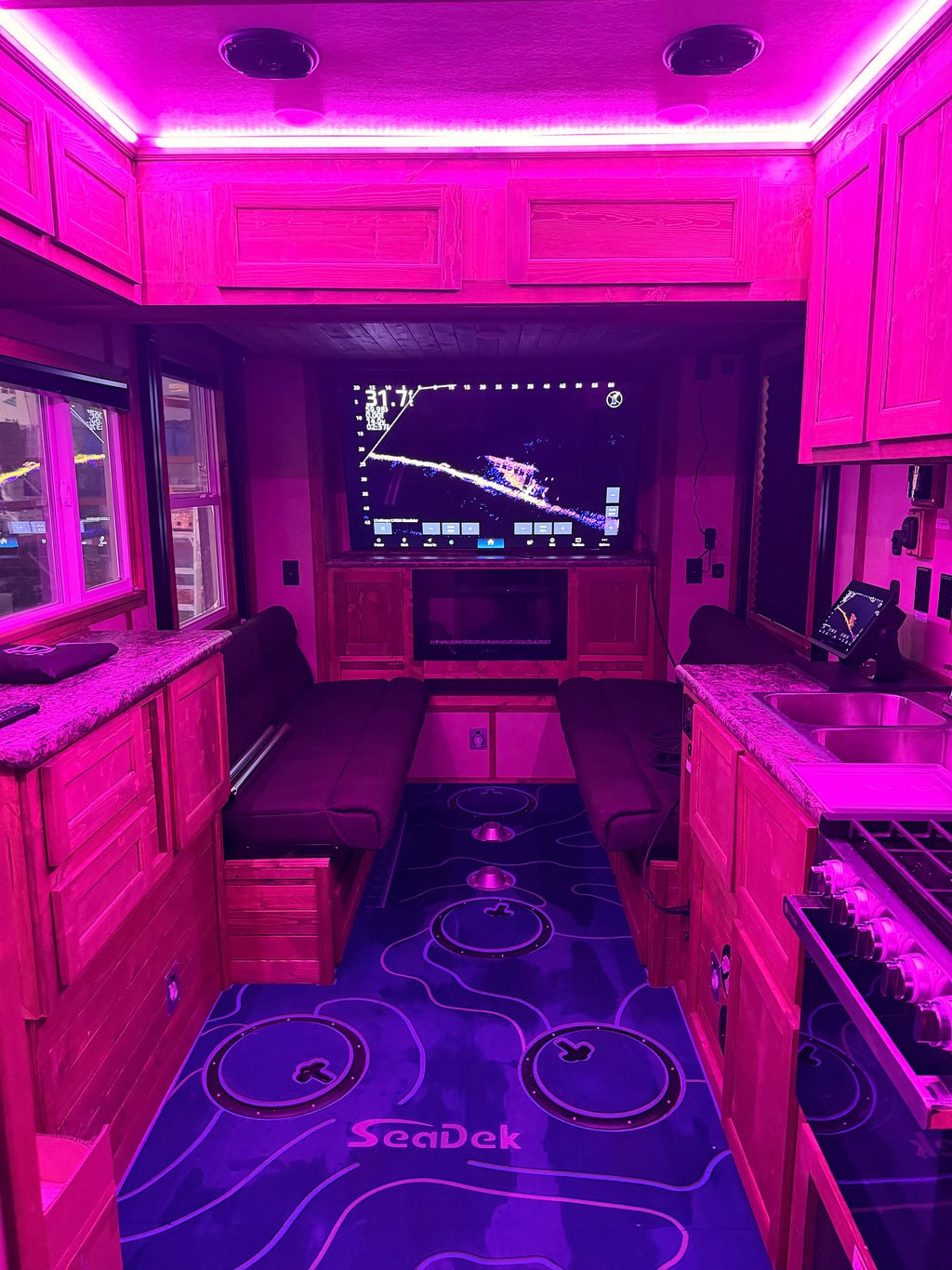 Fish house electronics and custom flooring under magenta accent lighting