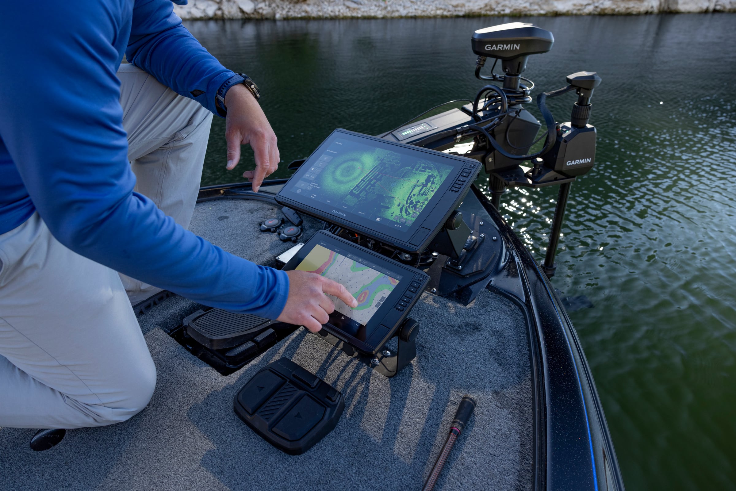 Angler using dual Garmin multifunction displays and bow electronics
